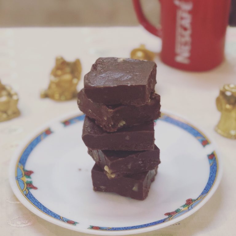 Stack of easy 3-ingredient chocolate fudge squares on a plate