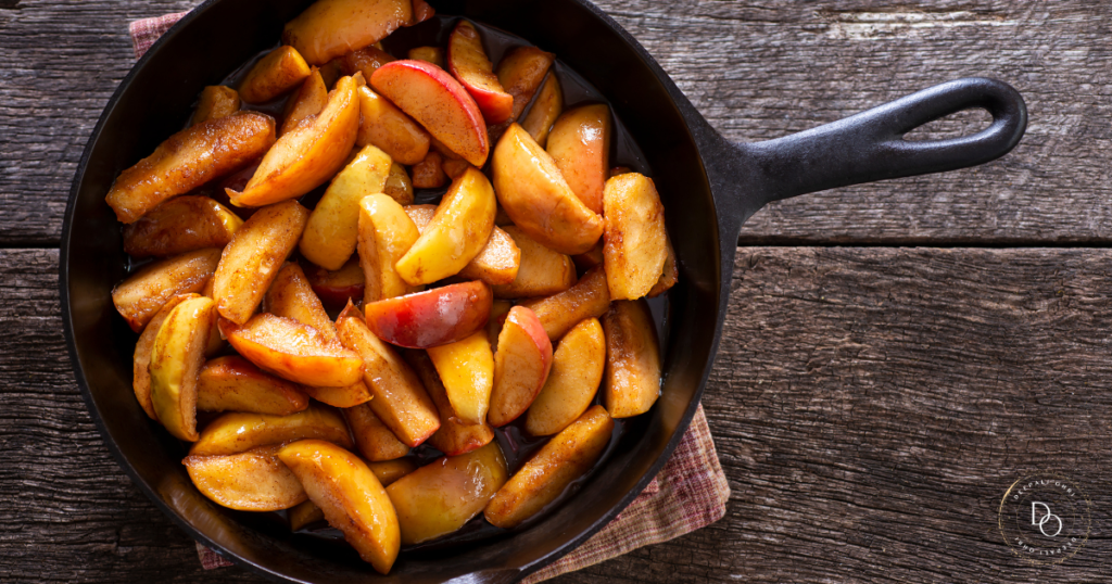 Baked apple slices served on a pan with honey drizzle