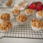 Eggless apple crumble muffins with crunchy streusel topping cooling on a wire rack
