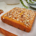 Eggless blueberry almond cake topped with sliced almonds baked in a square pan