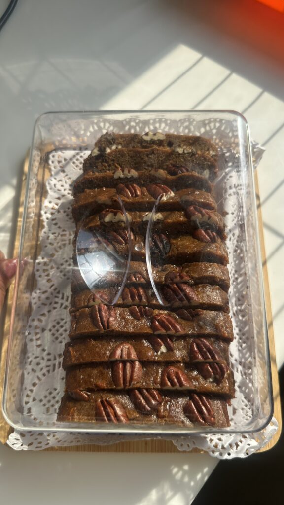 Eggless Date & Carrot Cake sliced and packed in a clear box