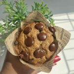 eggless chocolate chip banana muffins on a marble plate in warm sunlight