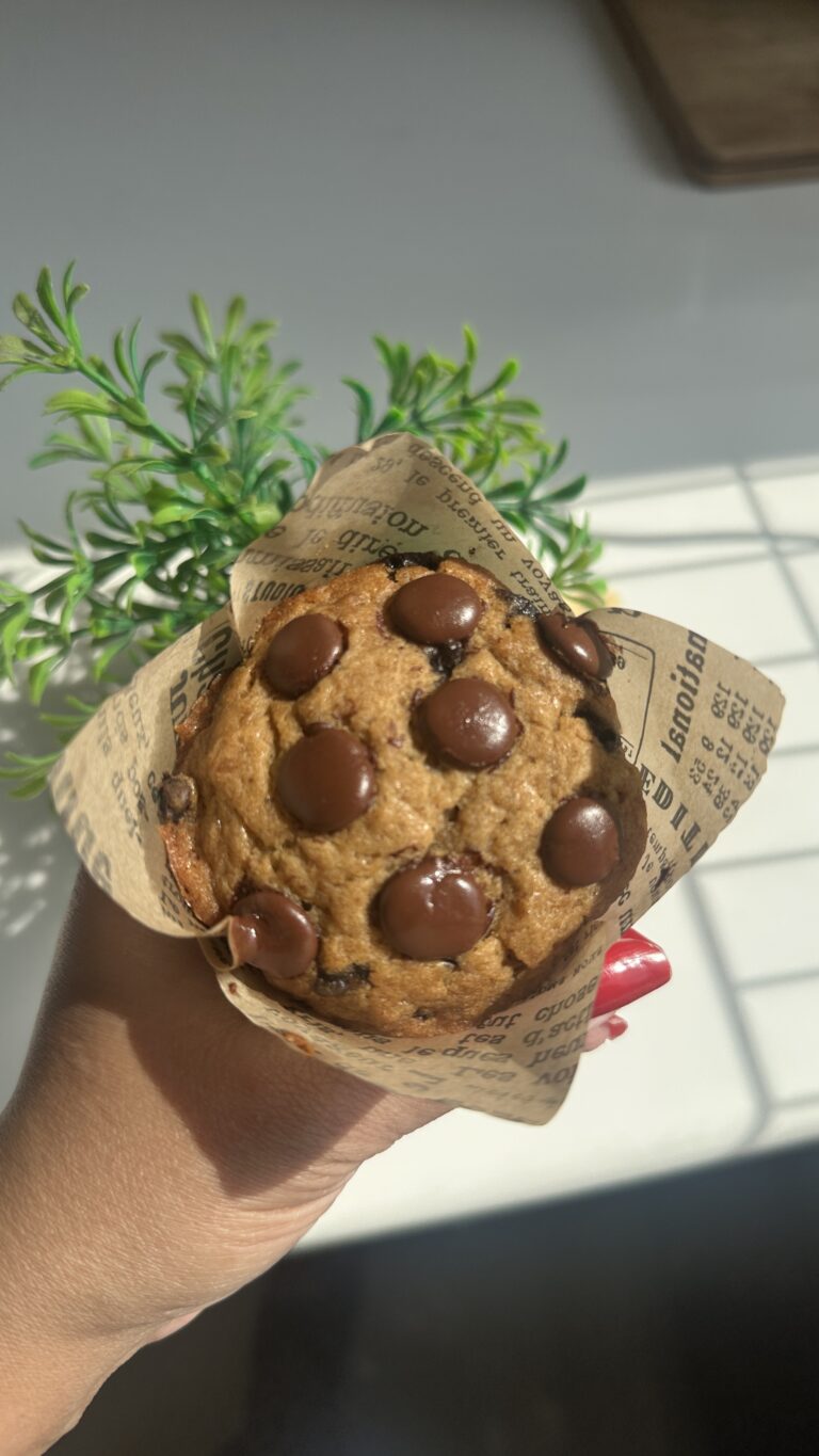 eggless chocolate chip banana muffins on a marble plate in warm sunlight