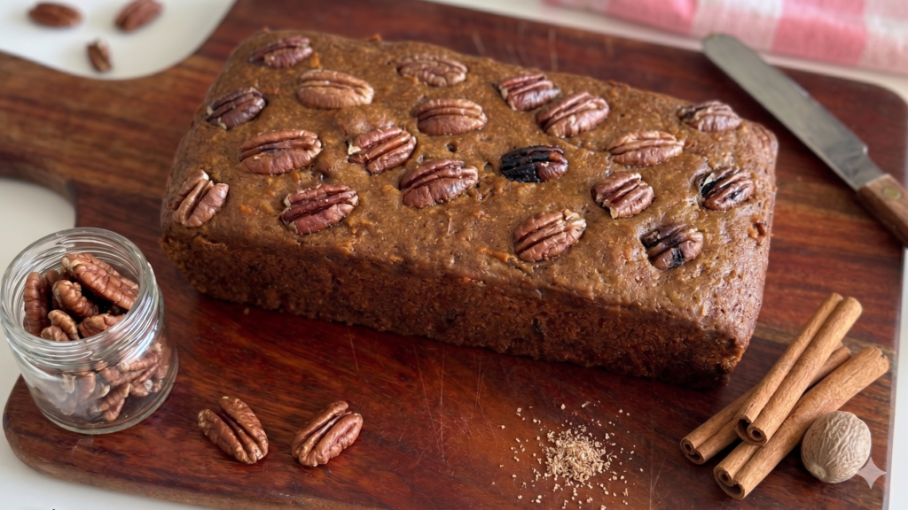 Eggless Date & Carrot Cake styled with cinnamon sticks, nutmeg and pecans