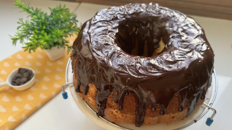 Large Batch Vanilla Bundt Cake (Soft, Moist & Foolproof) Large vanilla bundt cake with glossy chocolate glaze dripping down the sides on a wire rack