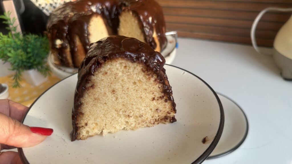 Slice of soft vanilla bundt cake showing a tender, moist crumb
