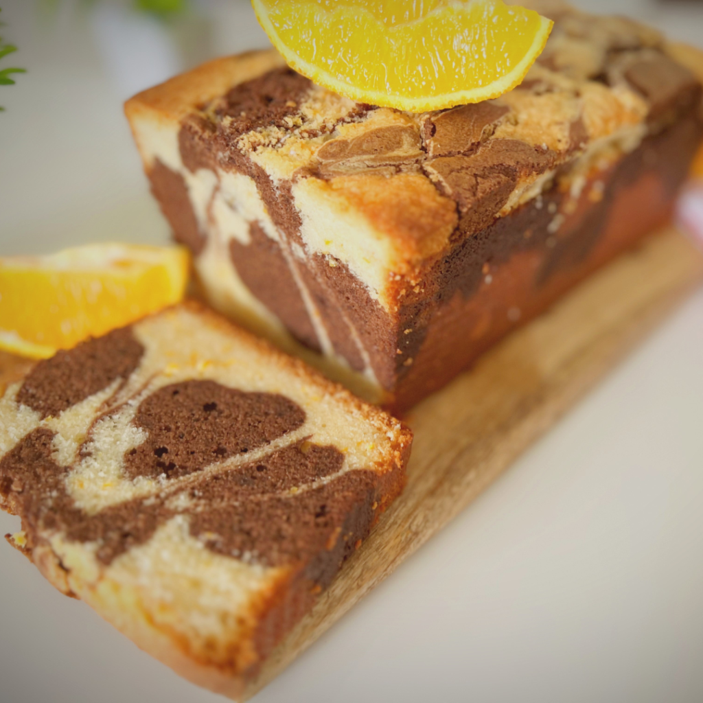 Top angle of chocolate orange marble cake topped with an orange slice