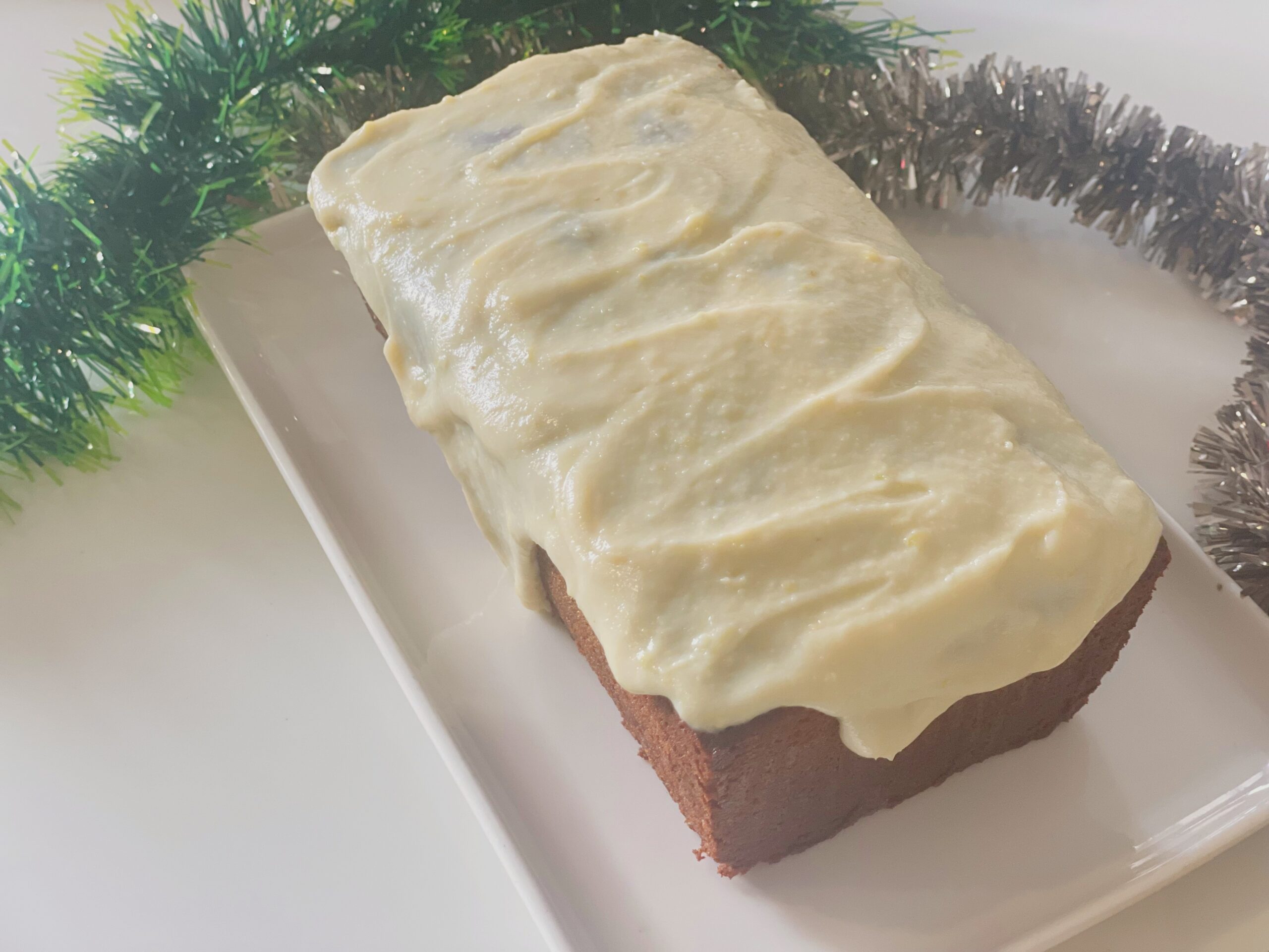 Close-up of condensed milk pound cake with a thick lime glaze top