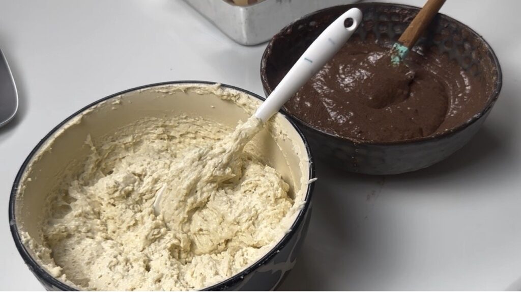 Vanilla and chocolate batters side by side for eggless marble cake