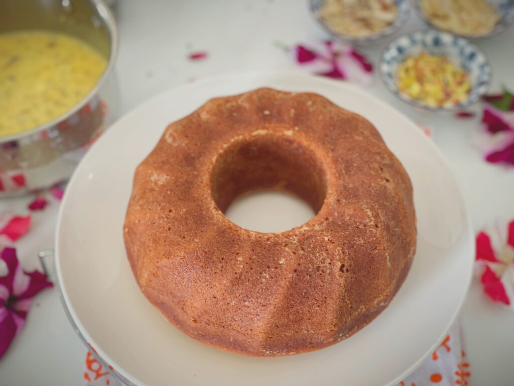Golden eggless cardamom bundt cake before soaking in rasmalai milk