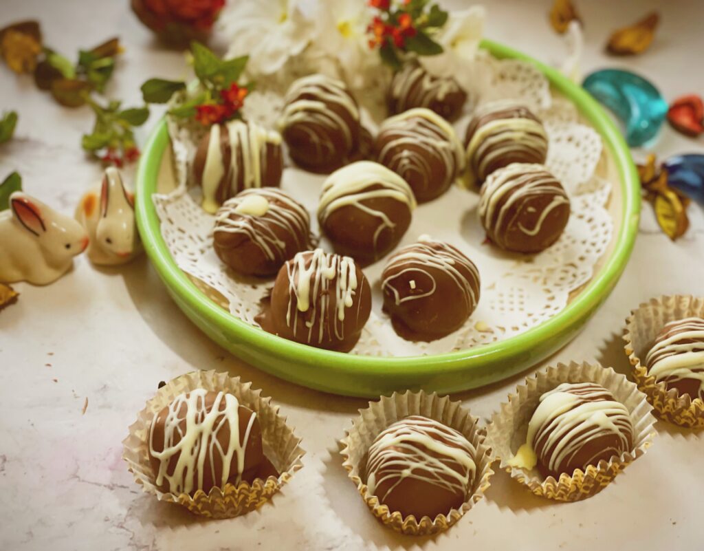 Chocolate coconut balls in a bowl and in paper liners for gifting