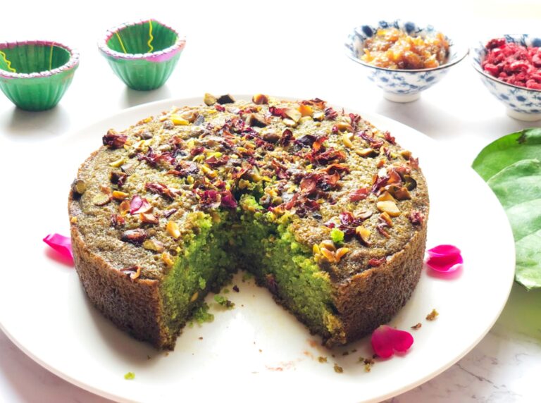 Eggless paan cake with a slice cut out, showing the soft green crumb