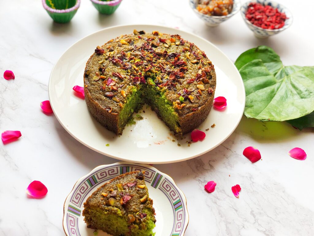 Eggless paan cake on a plate with a slice served alongside
