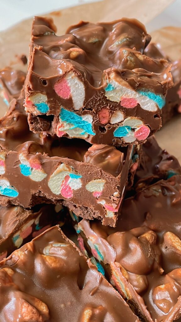 Close-up of chocolate marshmallow squares showing pink, blue and white marshmallows