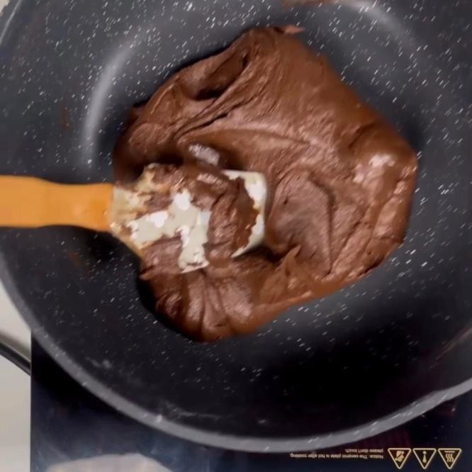 Chocolate peda mixture cooked until it leaves the sides of the pan