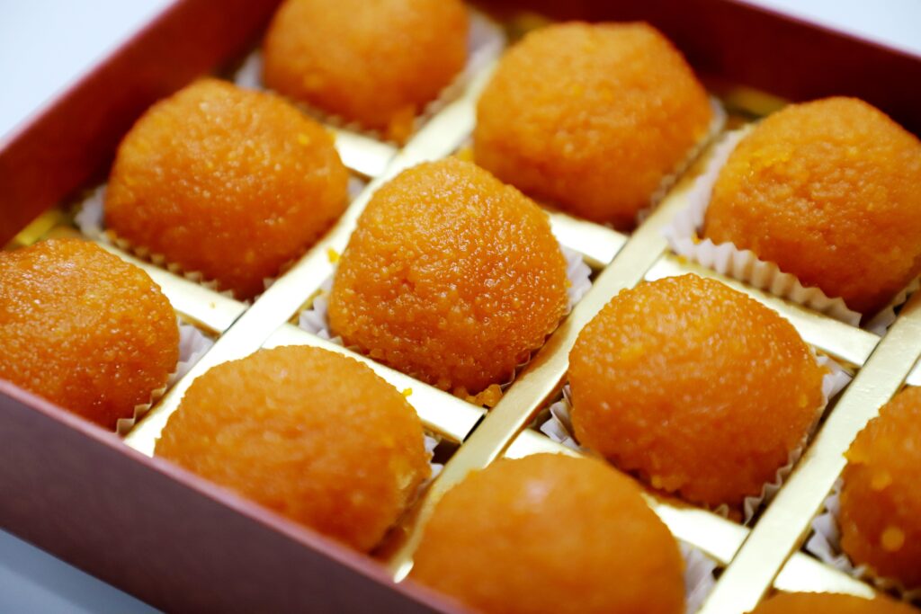 Motichoor ladoos in paper cups inside a Diwali gift box